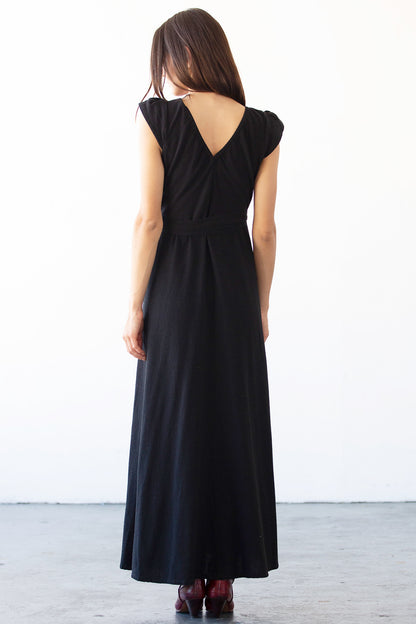 Woman wearing a black dress with a white background