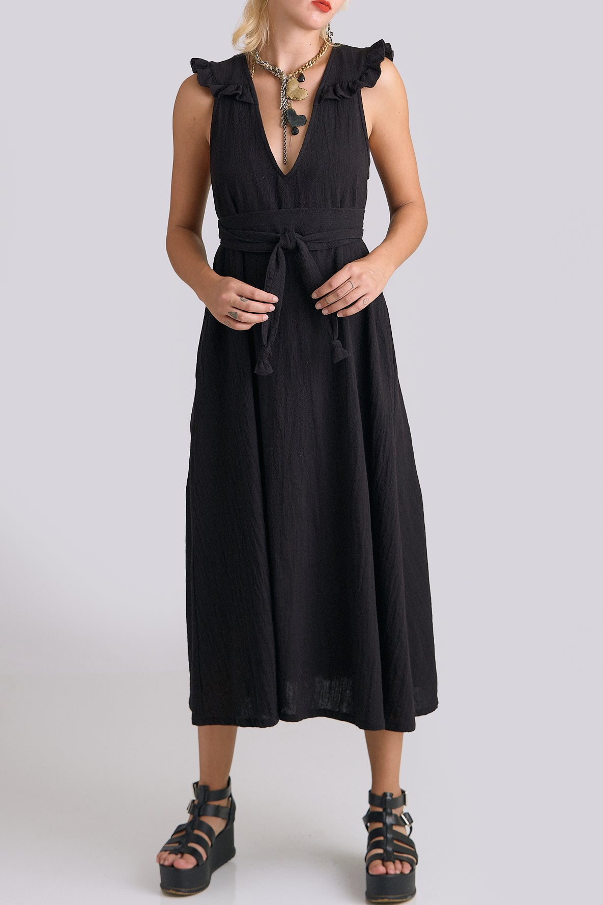 Black dress worn by a person on a white background